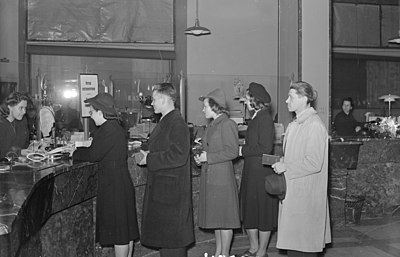 Customers queuing to bank counter in Finland with passbooks (1943)