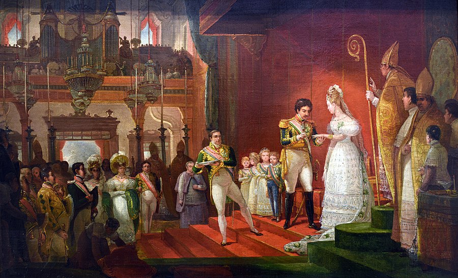 A man in uniform places a ring on the: finger of a woman in an elaborate white dress. Four small children stand behind him.