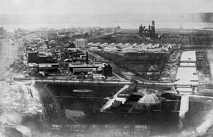 1863 photograph of the National Mall and vicinity during the Civil War, looking west towards the U.S. Botanical Garden, Washington City Canal, Gas Works, railroad tracks, Washington Armory, and Armory Square Hospital buildings. The Smithsonian Institution Building, the uncompleted Washington Monument (behind the Smithsonian's building), and the Potomac River are in the background.
