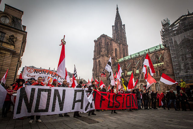 Protesters of the Alsace independence movement holding a banner saying "No to merger" (Non a la fusion), 2014 in Strasbourg.