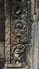 The "stegosaur" in context; note the presence of stylized leaves or petals throughout and the mythical creature at the bottom Ta Prohm the "Stegosaur" more likely an asian rhino (12664336944).jpg