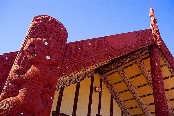 A wharenui (meeting house) at Ōhinemutu village, Rotorua, with a tekoteko on the top