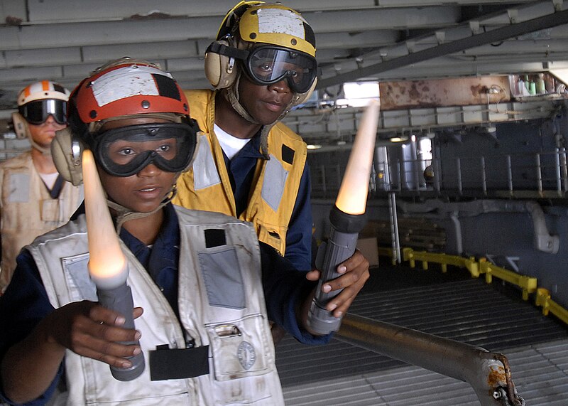 File:US Navy 100223-N-2000D-105 Boatswain's Mate 3rd Class Viviana Milos, from the Dominican Republic, as she directs an air-cushioned landing craft (LCAC) into the well deck of the amphibious dock landing ship USS Carter Hall (LSD.jpg