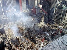 Overview of the site following the attacks. The Deutsche Bank Building is visible behind an angled red crane. WTCgroundzero.jpg