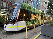 E class tram on shuttle route 57a at the Flinders Street terminus in September 2023 Yarra Trams E-class 6061 Route 57a, September 2023.jpg