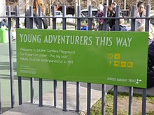 Sign at the entrance to the playground in Jubilee Gardens next to County Hall, London, noting that it is for under 11s only and that adults must be accompanied by a child. Young Adventurers This Way, Jubilee Gardens.jpg