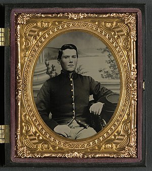 Private Jonathan Colgrove of Co. F, 57th Pennsylvania Infantry Regiment, in uniform (Private Jonathan Colgrove of Co. F, 57th Pennsylvania Infantry Regiment, in uniform in front of painted backdrop showing column base and landscape) (LOC) (14565614685).jpg