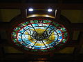 Stained glass depicting the Holy Spirit on the ceiling above the altar