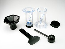 The original AeroPress made of clear plastic with its accessories. Not to be confused with the new AeroPress Clear product