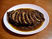 A Lombard brasato di maiale (pork stew) is considered a second course. Brasato di maiale nero.jpg