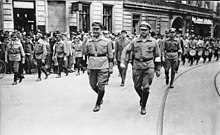 Communist Party (KPD) leader Ernst Thalmann (person in foreground with raised clenched fist) and members of the Roter Frontkampferbund (RFB) marching through Berlin-Wedding, 1927 Bundesarchiv Bild 183-Z0127-305, Berlin 1927, Reichstreffen RFB, Thalmann, Leow.jpg