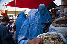 Burqa clad women bying at a market.jpg