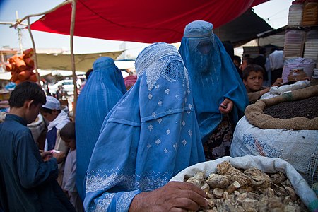 Burqa clad women bying at a market.jpg