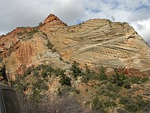 Cross-bedding in lithified aeolian sand dunes preserved as sandstone in Zion National Park, Utah Cross-bedding Of Sandstone Near Mt Carmel Road Zion Canyon Utah.jpg