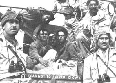 Arab Legion commander Abdullah el Tell (far right) with Captain Hikmat Mihyar (far left) pose with Jewish prisoners after the fall of Gush Etzion