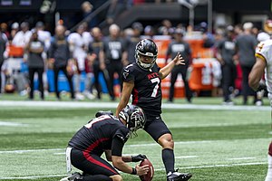 Younghoe Koo (left) of the Atlanta Falcons attempts a field goal, while Cameron Nizialek (right) serves as the holder. Falcons 369.jpg