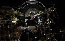 Fleetwood in 2013, surrounded by his extensive drum kit Fleetwooddrumming2006.jpg