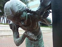 Sculpture in Downtown Asheville of a girl drinking from a fountain shaped like a horse