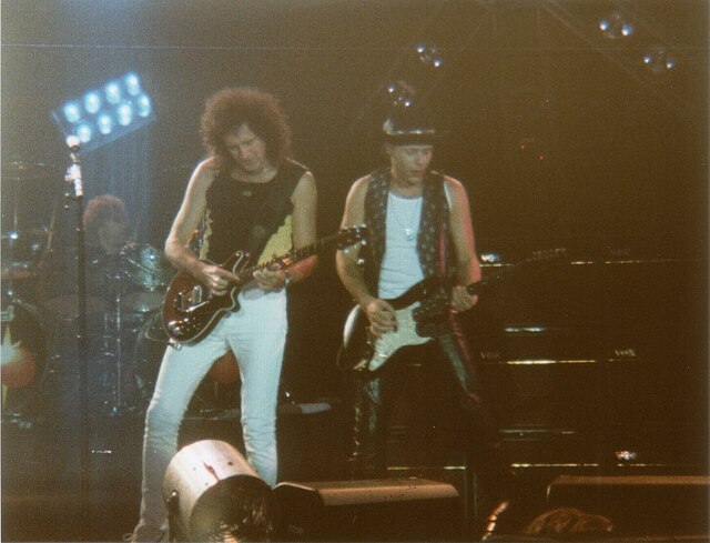 Moses (right) performing with The Brian May Band in 1998