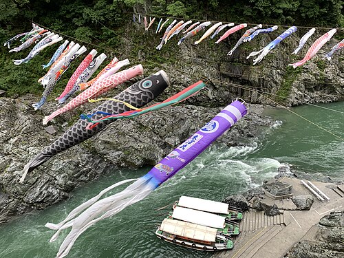 Koinobori (carp streamers; fish kites) flying over Oboke Gorge, Tokushima Prefecture, Shikoku, Japan.jpg