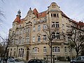 Apartment house in a corner and semi-open development