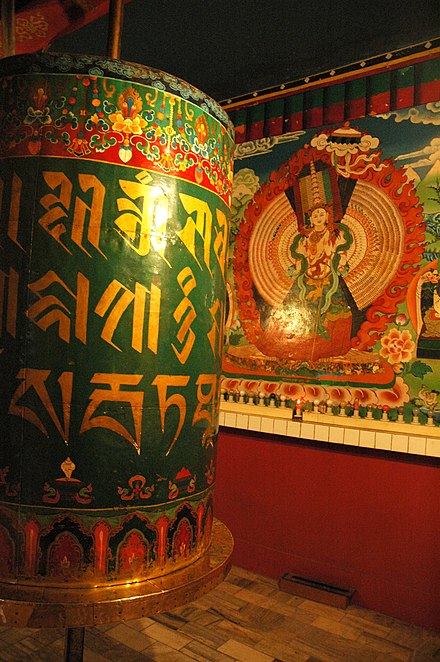 Giant prayer wheel and thangka of Arya Sitatapatra, a form of Tara, at Tsuglagkhang