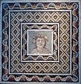 Pavement mosaic with a bust of Dionysos. Roman artwork, 3rd century CE.