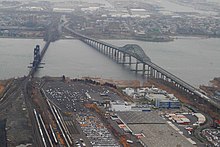 The Upper Bay Bridge for trains and the Newark Bay Bridge for vehicles cross Newark Bay east of Oak Island Yard Newark Bay Bridge, New Jersey.jpg