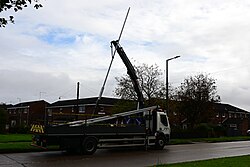 Here, a HIAB crane mounted to the flatbed lorry lifts the new Fabrikat post from the bed and into the sky.