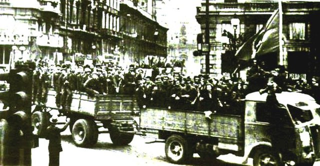 Italian partisans parade in vehicles through the streets of Bologna after the liberation of the city (21 April 1945).