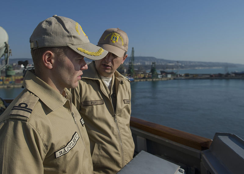 File:Romanian Naval Forces Lt. j.g. Radu Radulescu, left, and Chief Warrant Officer Daniel Andrei Pap watch from the guided missile destroyer USS Truxtun (DDG 103) as the ship pulls into Varna, Bulgaria, March 13 140313-N-EI510-116.jpg