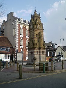 Clock tower on St Peter's Square. In the background are the Myddleton Arms pub, Castle Hotel, and HSBC bank