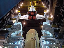 A crane lowers Discovery toward the ET and SRBs in high bay 3 of the Vehicle Assembly Building for STS-124. Space Shuttle Discovery lowered toward external tank and solid rocket boosters (STS-124).jpg