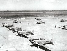 North American AT-6 Texan advanced flight trainers, 1943. "SP" was the fuselage code for Spence AAF Spence Army Airfield - North American AT-6 Texans on Parking Ramp.jpg