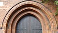 St Olave's Church, Woodberry Down, Manor House, London, 1893 by Ewan Christian, stepped and moulded arch over the south door with ornamental brickwork