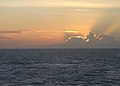 Sunset over milne bay (10727619506).jpg