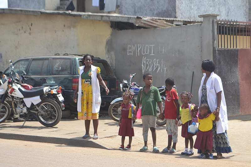 File:Teachers helping students cross the raod.jpg