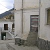 A street corner in Trevélez showing traditional architecture and door curtain