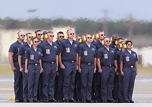 US Navy 060813-F-7049H-045 Crew chiefs with the United States Naval Flight Demonstration Squadron stand at attention as the Blue Angels prepare to disembark on their aerial performance.jpg
