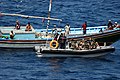 US Navy 071129-N-6794Z-002 A boarding team launched from French Navy Ship (FS) Guepratte (F 714) delivers a case of bottled water to a fishing dhow off the coast of Djibouti.jpg