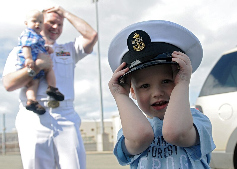 File:US Navy 110310-N-DX615-069 The son of Chief Information Systems Technician Jess Eisele wears his father's cover during a celebration for the arriva.jpg