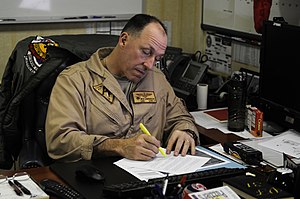 US Navy 120122-N-RG587-021 Capt. Rick LaBranche, commander of Carrier Air Wing (CVW) 17, reviews documents in his office aboard the Nimitz-class ai.jpg