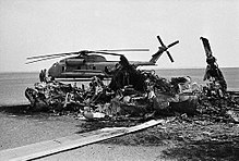 Wreckage of one of the destroyed Bluebeard helicopters with an abandoned RH-53D behind Usburnedhelicopter.jpg