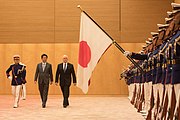 Japan Self-Defense Forces honor guards holding the national flag during Mike Pence's visit.