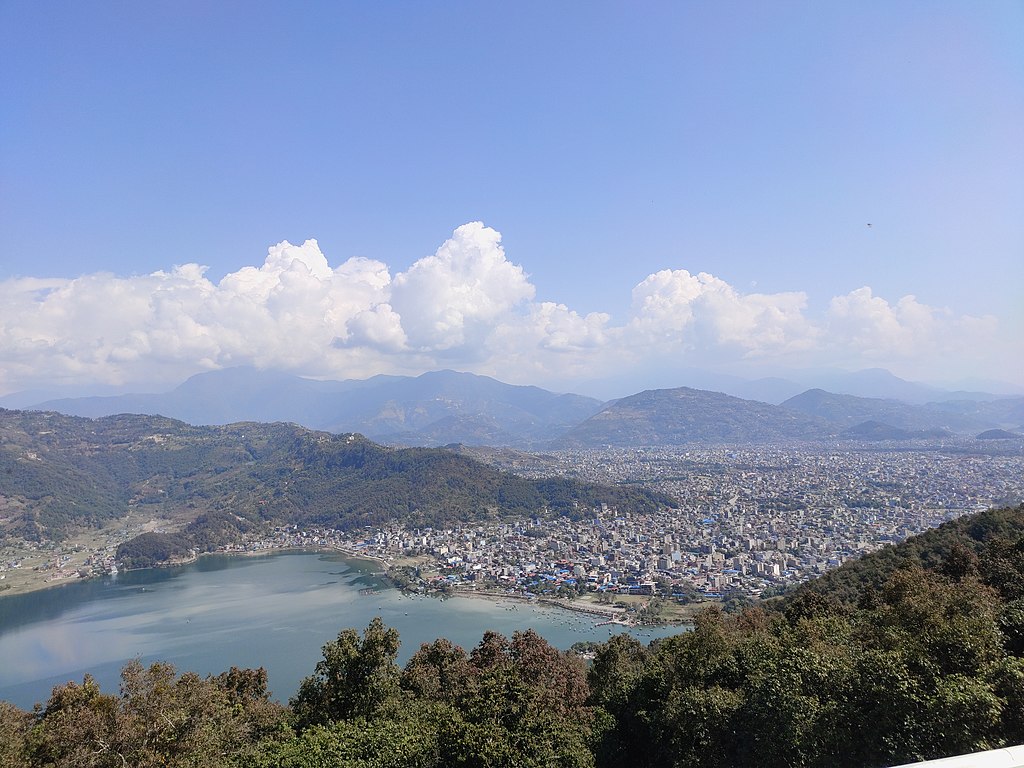 Premium Photo | Colorful boats symbol of phewa lake shore with fog in the  morning ,pokhara nepal.