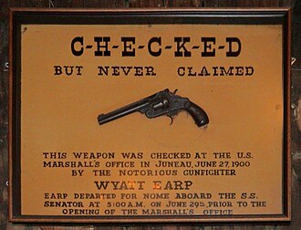 Said to be Wyatt Earp's pistol, left behind in Juneau, Alaska, but Earp was arrested in Nome three days before the date on the sign. Wyatt Earp gun Red Dog Juneau.jpg