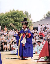 A mudang performing a kut ritual in Seoul, South Korea. seoulsaenamgus.jpg