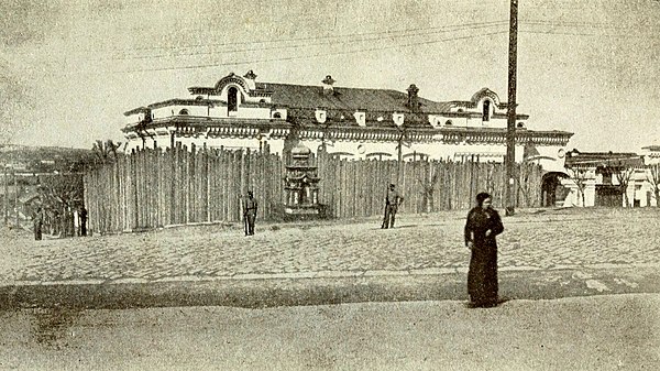 Ipatiev House, with the palisade erected just before Nicholas, Alexandra and Maria arrived on 30 April 1918. On the top left of the house is an attic 