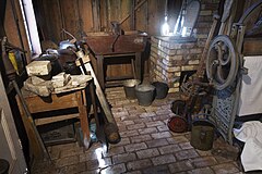 19th century toolshed with iron handtools, shoe repair bench, laundry press and other paraphernalia. Victorian Village, Museum of Transport and Technology (MOTAT) , Auckland, New Zealand.