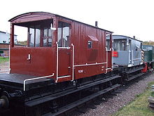 Horizontal and vertical grab bars (white) on the sides of British railroad brake vans. 952282 and 287664 in the platform.JPG